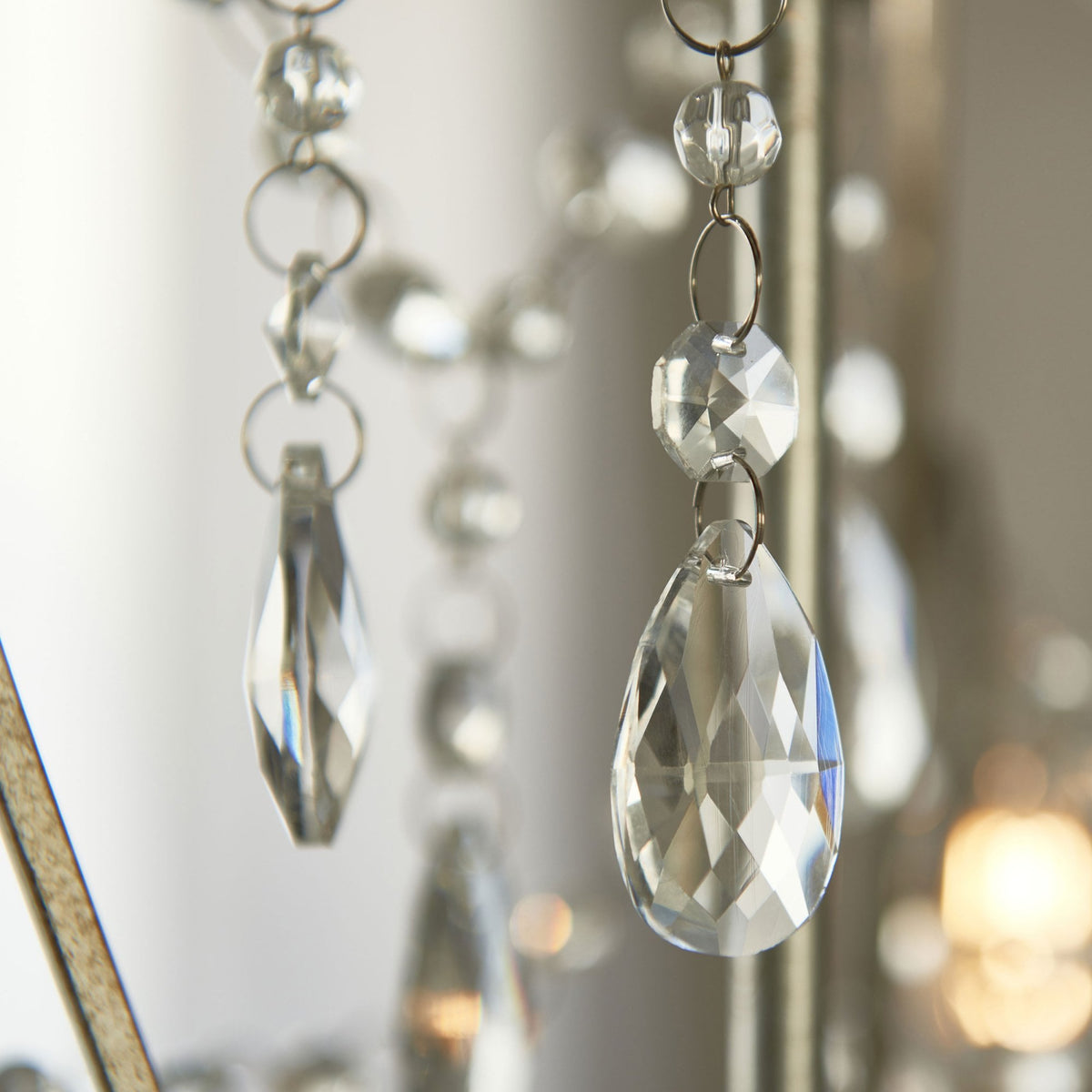 Close-up of the crystal teardrop and round pendants on a chandelier.