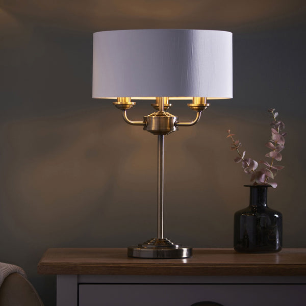 Highclere Three Light Table Lamp in Antique Brass with Vintage White Shade