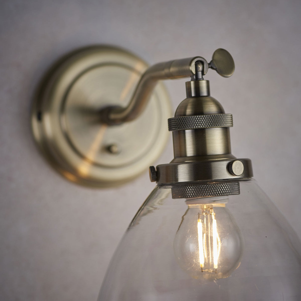 Hansen Wall Light in Antique Brass and Clear Glass Shade