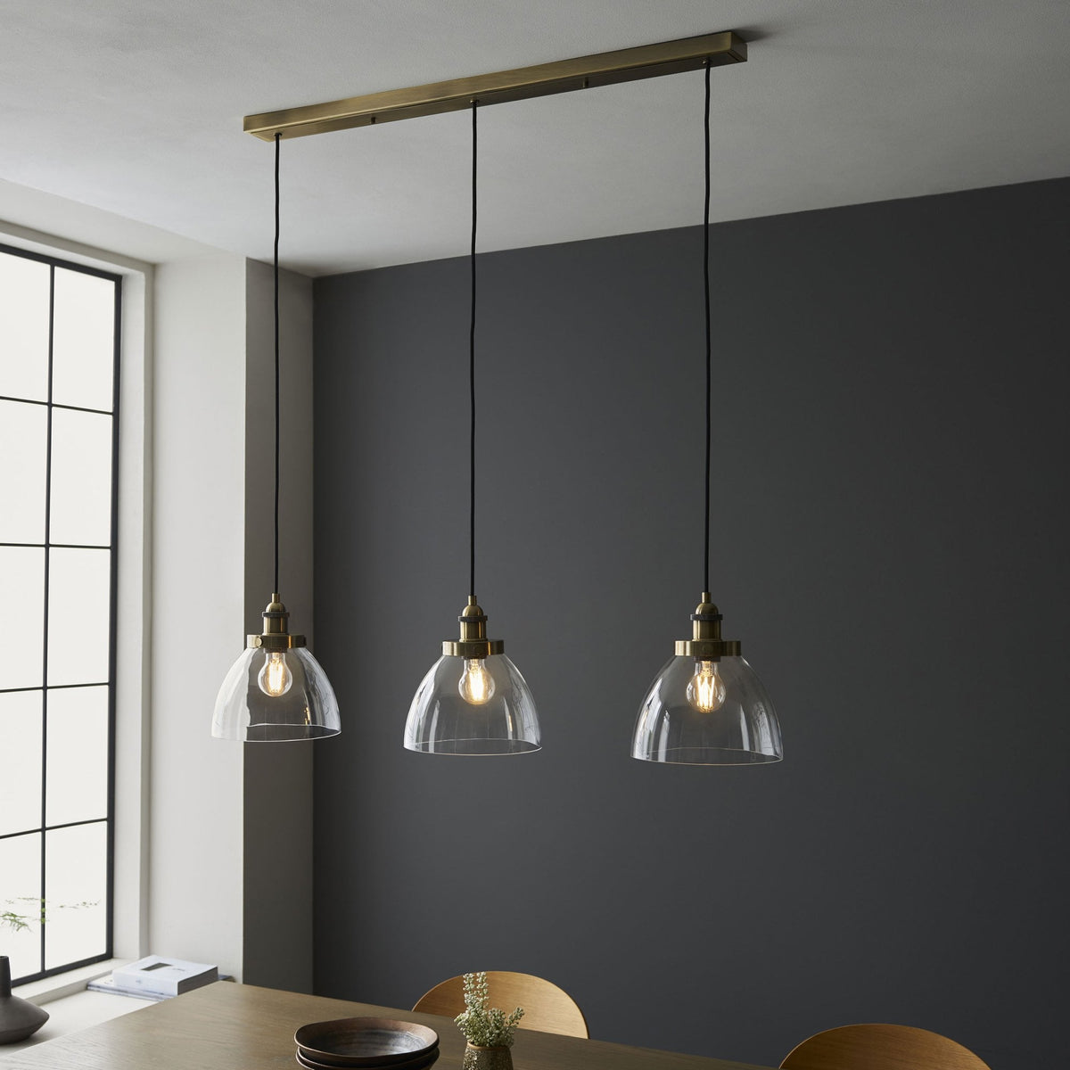Hansen Triple Drop Linear Pendant in Antique Brass and Clear Glass Shades