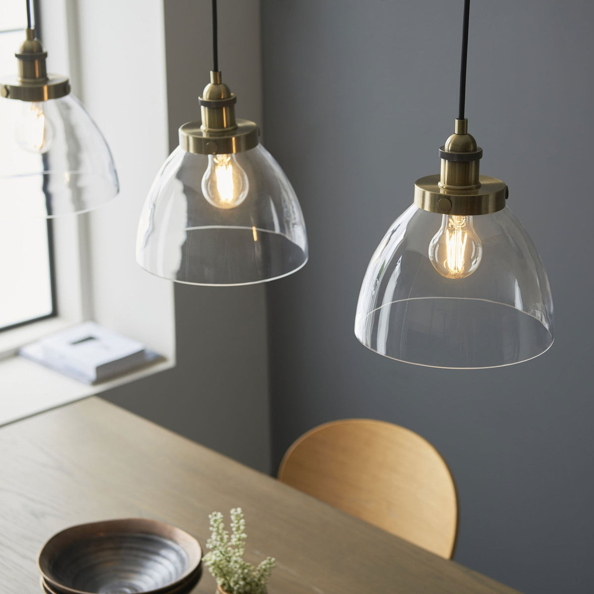 Hansen Triple Drop Linear Pendant in Antique Brass and Clear Glass Shades