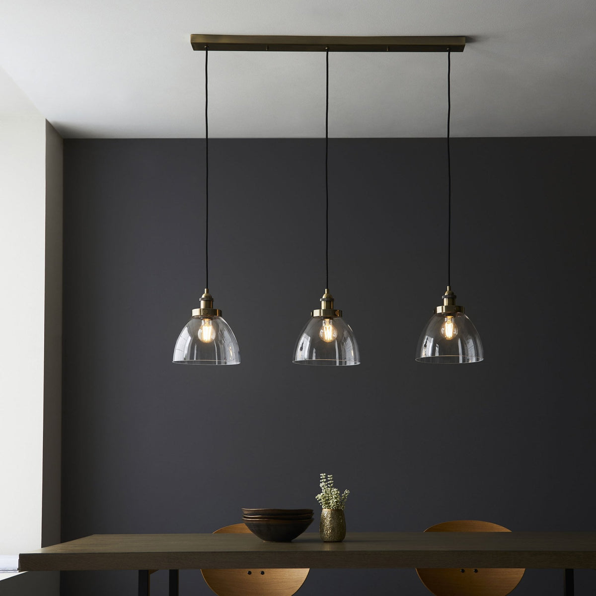 Hansen Triple Drop Linear Pendant in Antique Brass and Clear Glass Shades