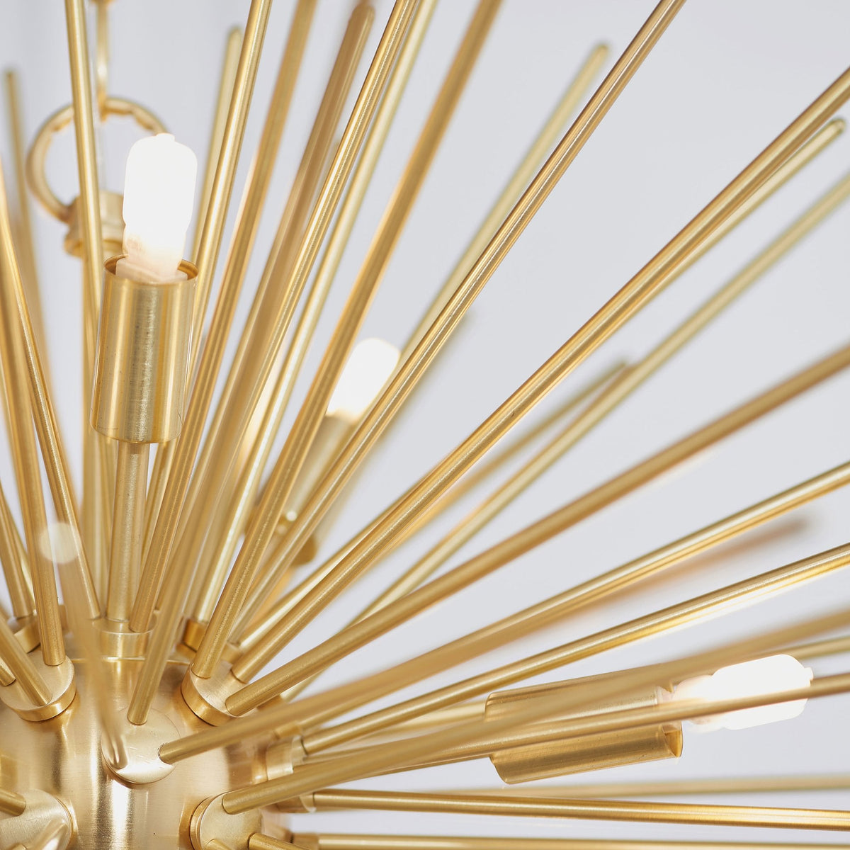 Detailed view of the gold sputnik chandelier, highlighting the texture and arrangement of the arms and bulbs.