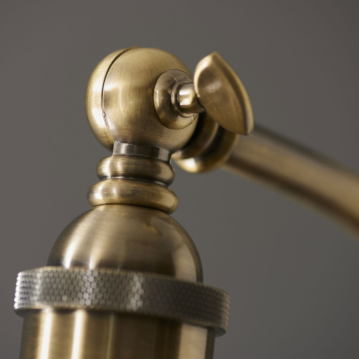 Detailed view of the lamp's adjustable brass joint, showcasing its intricate design and mechanism.