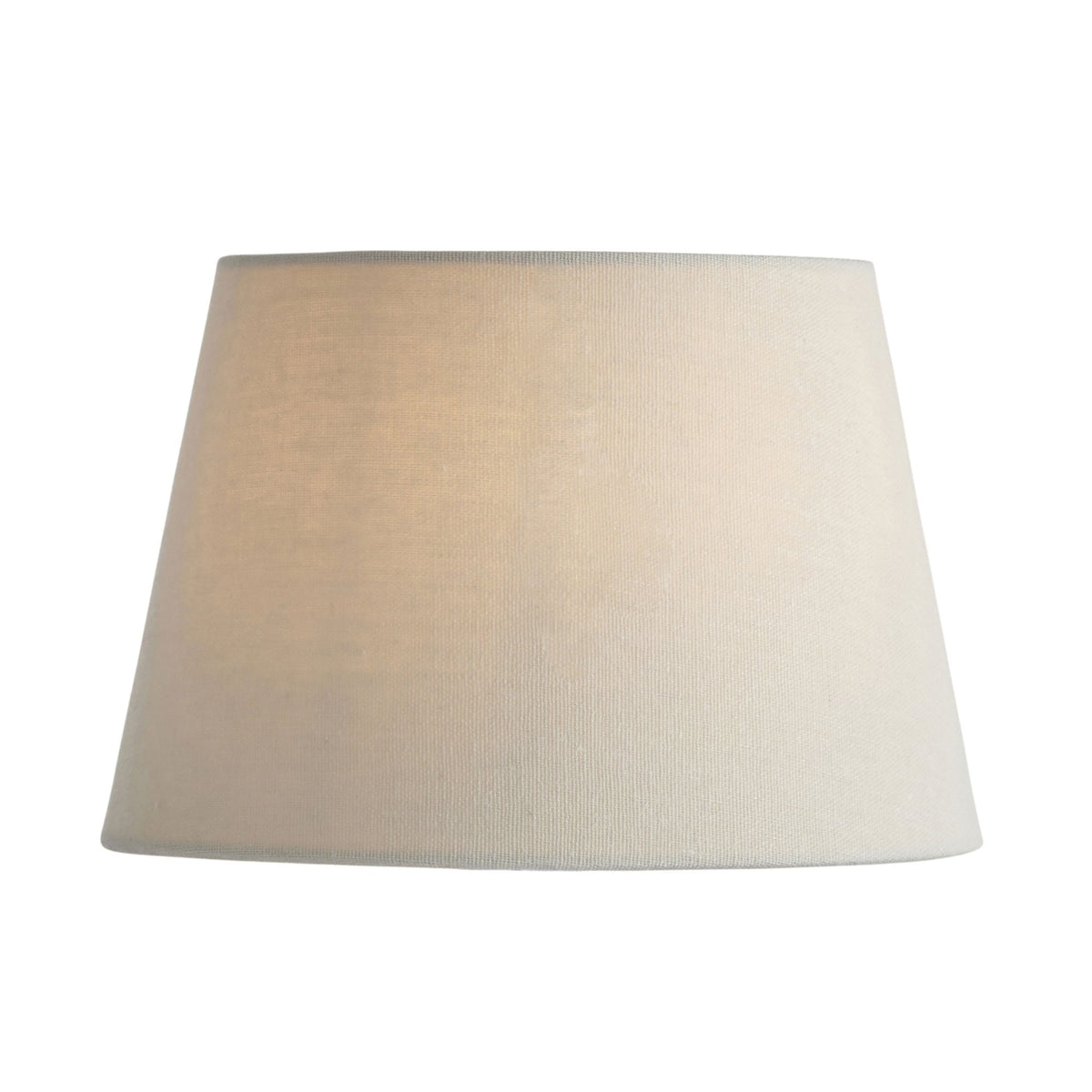 Tapered drum lampshade in natural linen, casting a warm glow.