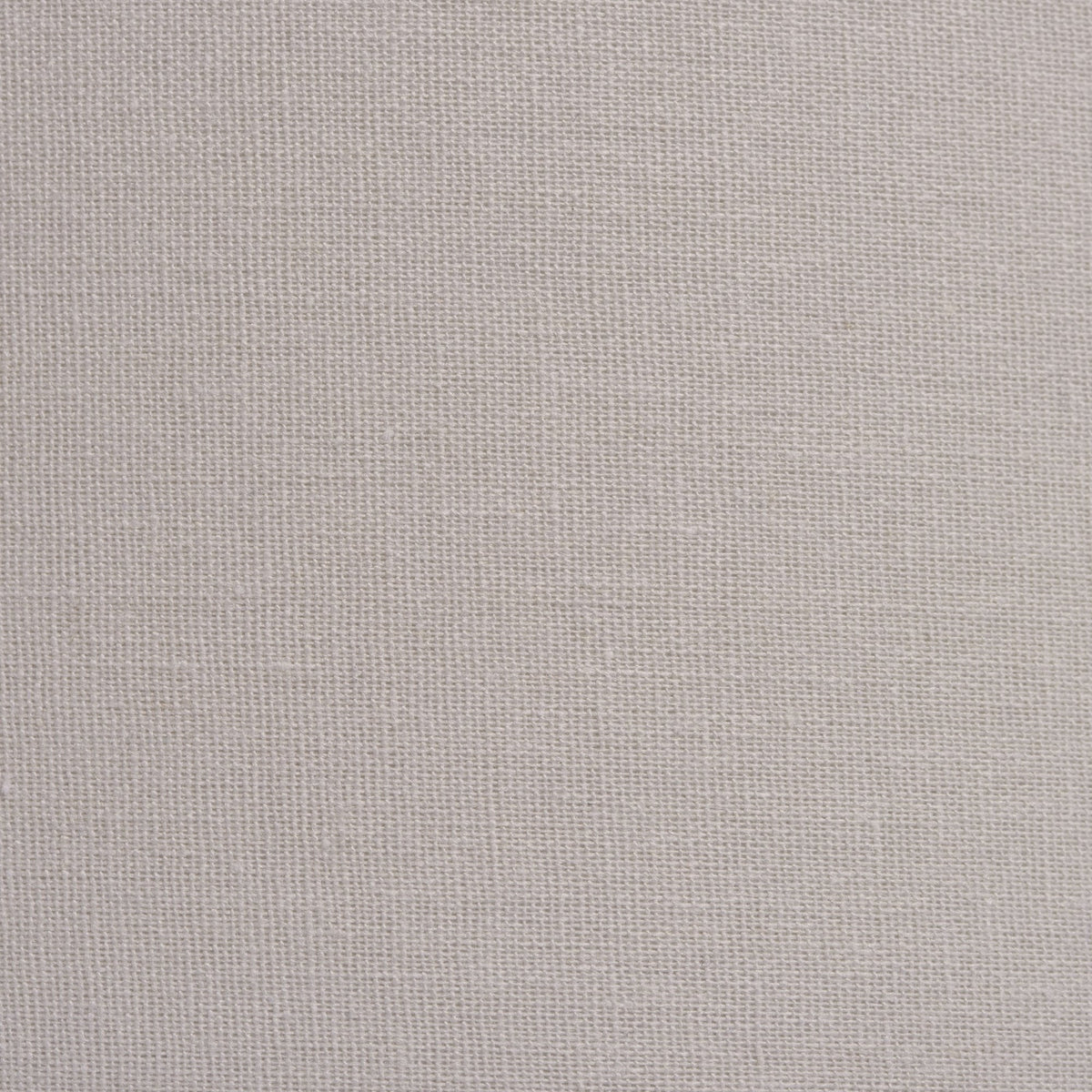 Close-up of natural linen fabric with a visible weave.