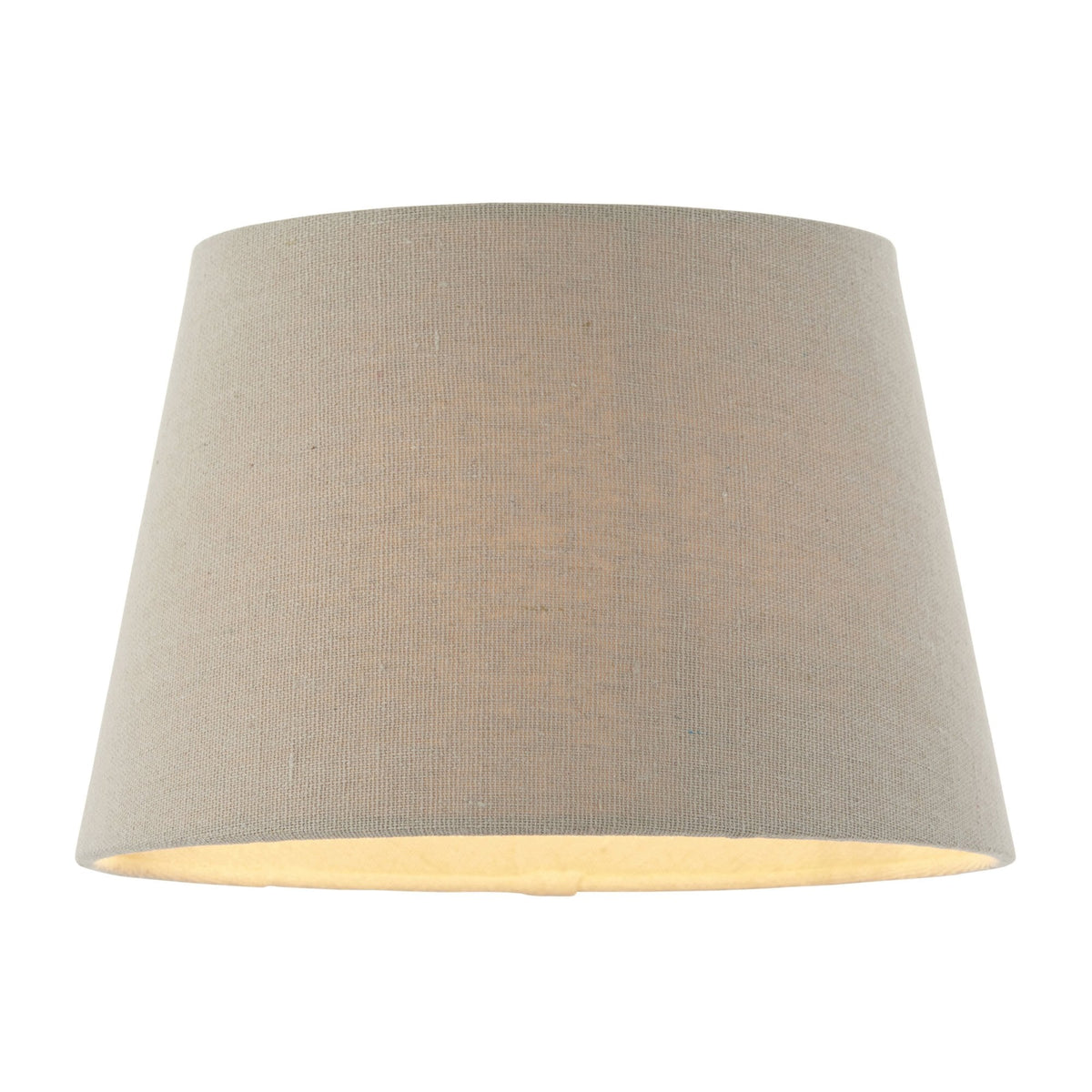 Tapered drum lampshade in natural linen, illuminated from within, casting a warm glow.