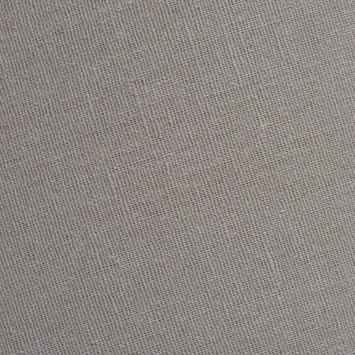 Close-up texture of natural linen fabric, showing the woven pattern and subtle variations in tone.