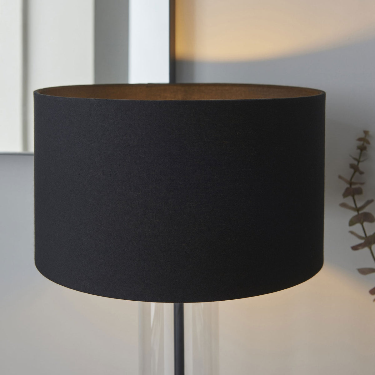 Close-up of the black fabric lampshade with a gold interior, emphasizing its elegant texture and warmth.