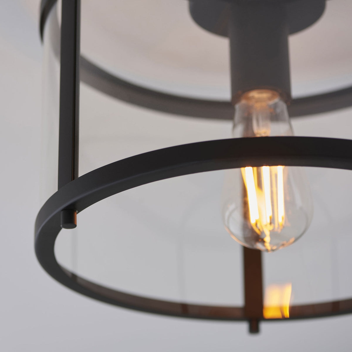 Detailed close-up of the flush-mount ceiling light, showing the bulb and glass enclosure.