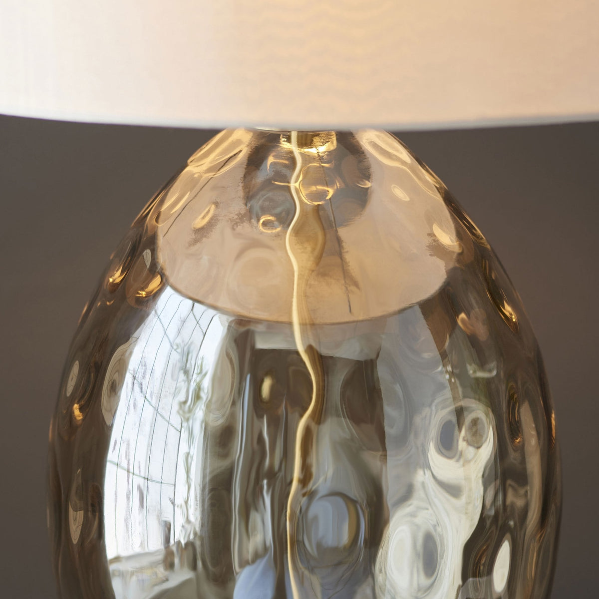 A close up of the light's base and neck, showing the dimpled texture.