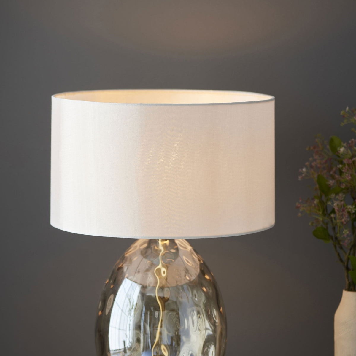 A close up of the white shade of the lamp.