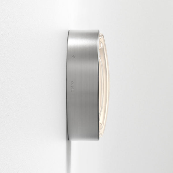 Astro branded wall light with a brushed metal finish and a curved glass diffuser