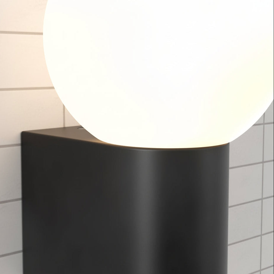 Black wall light with a large spherical white bulb