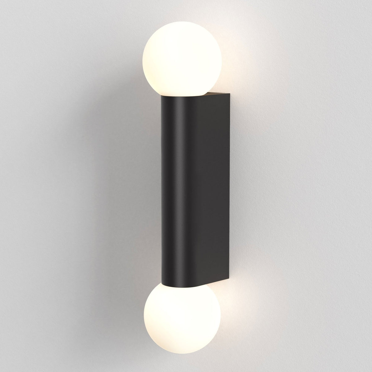 Black cylindrical wall light with two spherical white bulbs, one at the top and one at the bottom