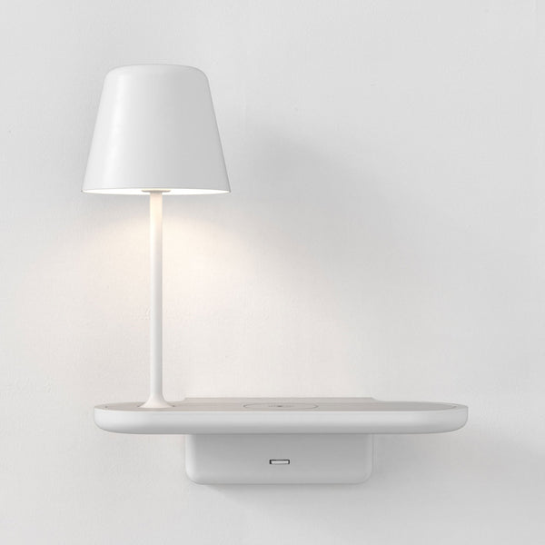 White wall-mounted lamp with a cylindrical shade and a shelf with a wireless charging pad and USB port
