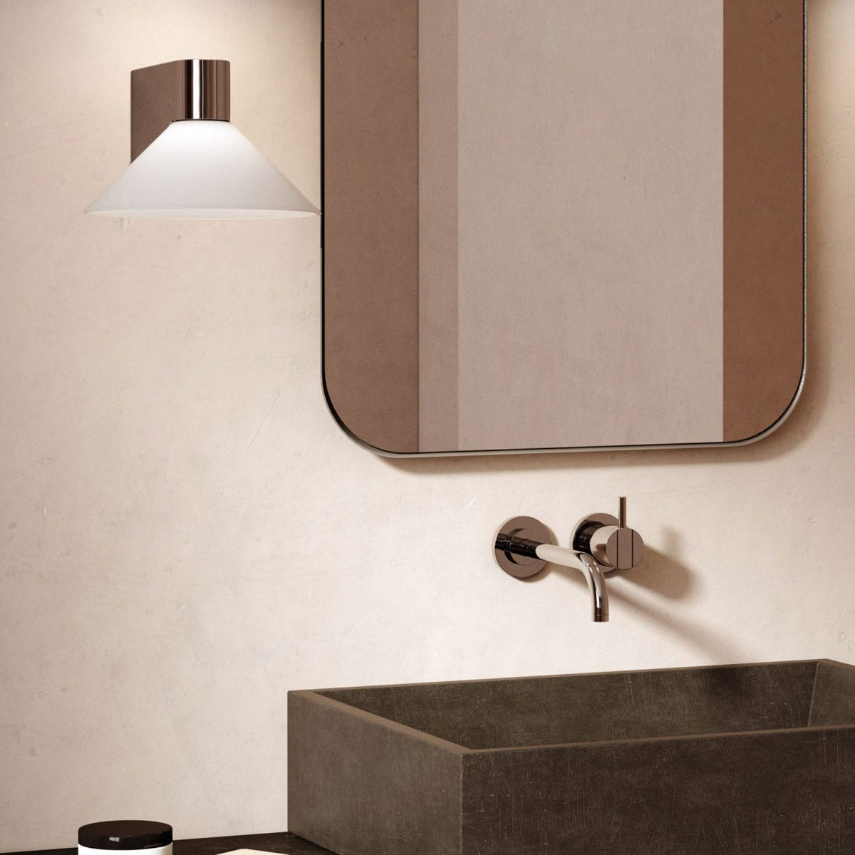 Bathroom vanity with a rectangular mirror, a wall-mounted faucet, and a dark stone sink