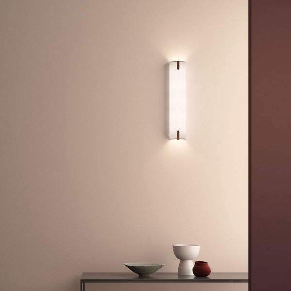Wall sconce with a rectangular white shade and two small brown accents
