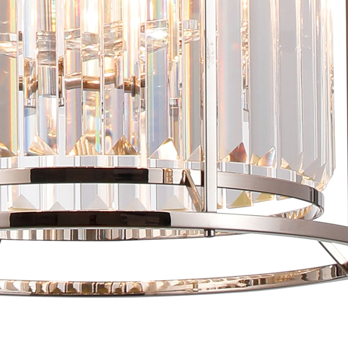 Close-up of a crystal chandelier with reflective surfaces and a polished chrome frame.