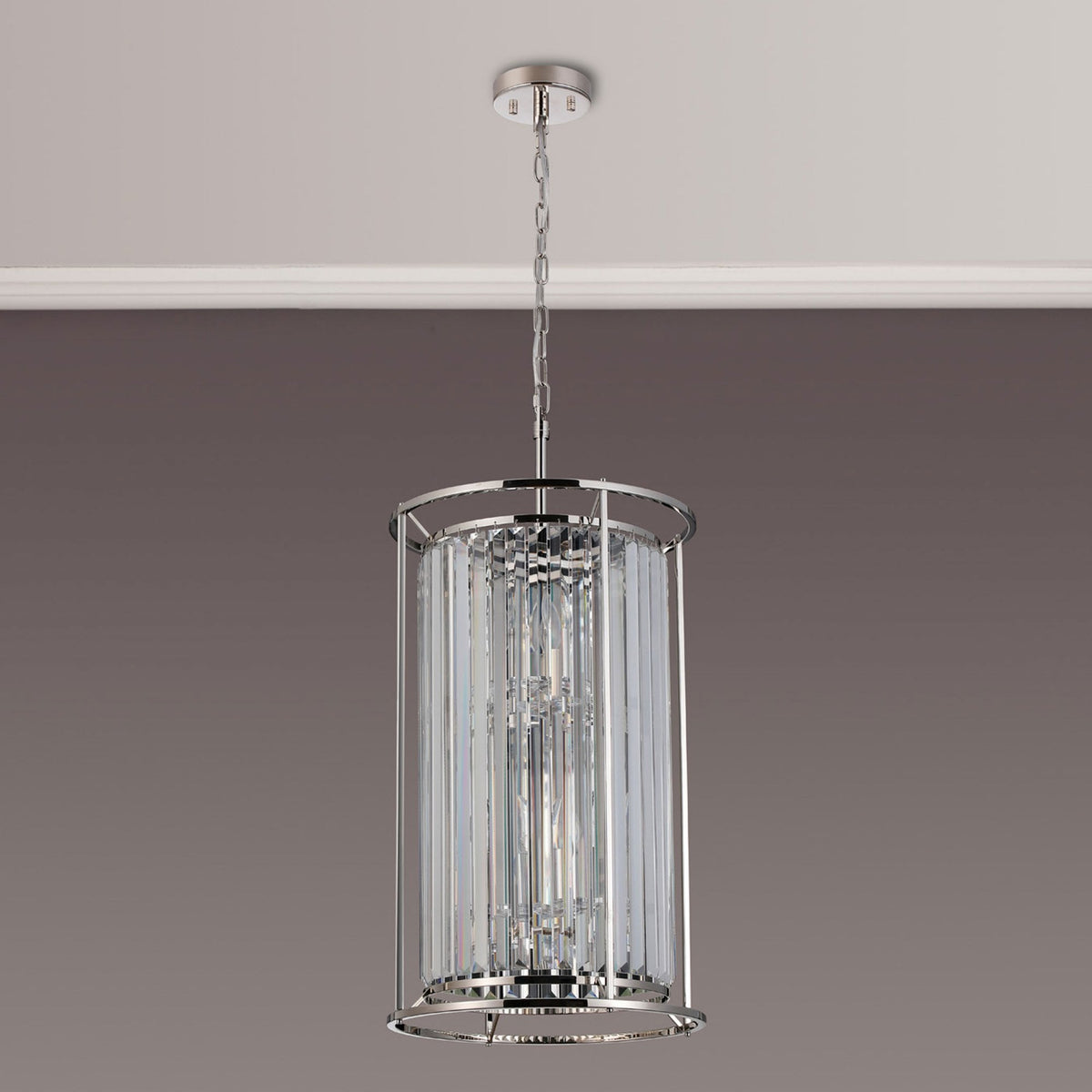 Cylindrical chandelier with clear crystal rods and a polished chrome frame, hanging from a ceiling.