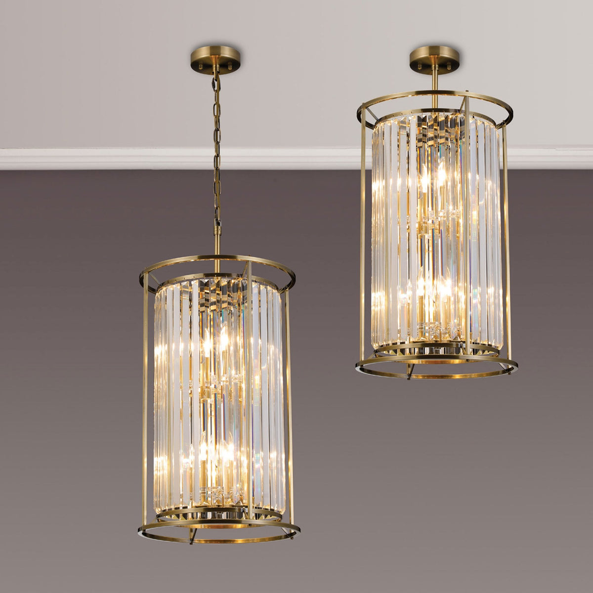 Two cylindrical crystal chandeliers with brass frames, one hanging and one flush-mounted, illuminate a room.