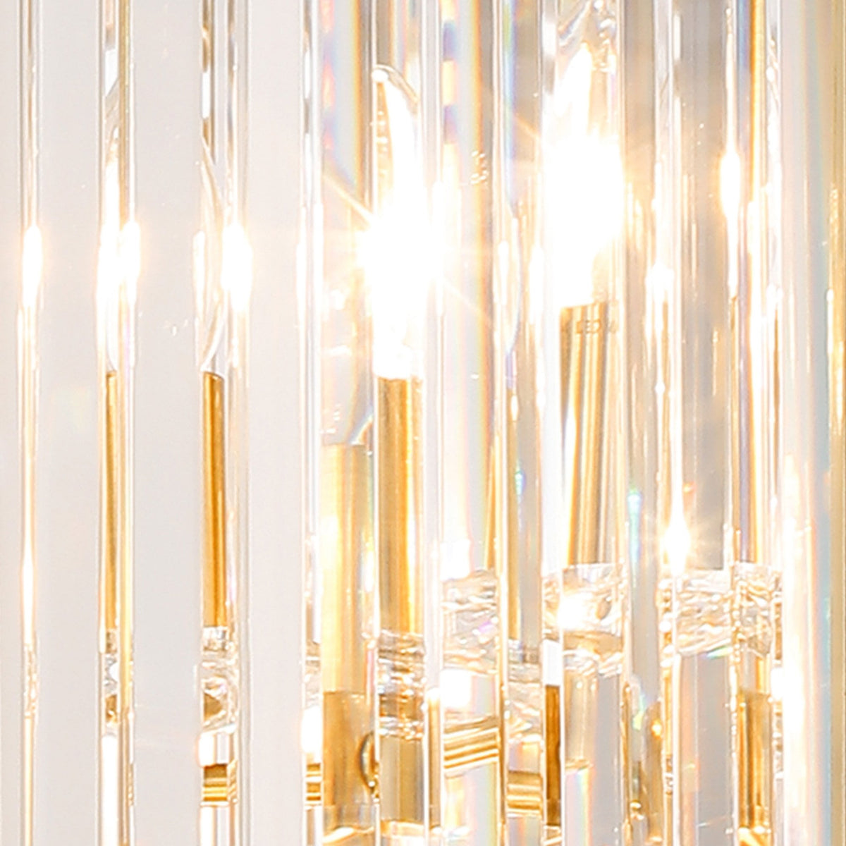 Close-up of a modern crystal chandelier with glowing bulbs and golden accents.