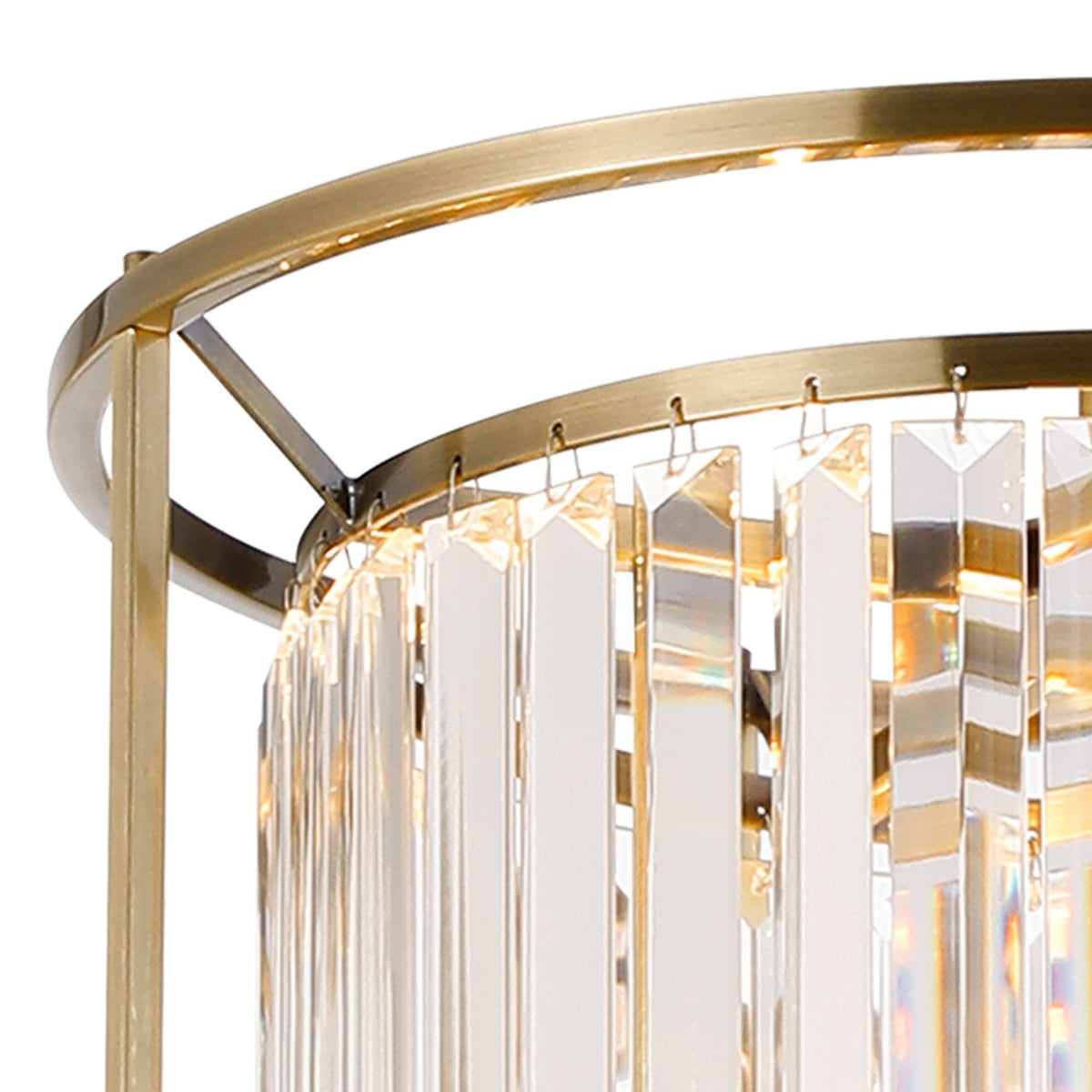 Close-up of a brass chandelier with hanging clear crystal rods, reflecting light.