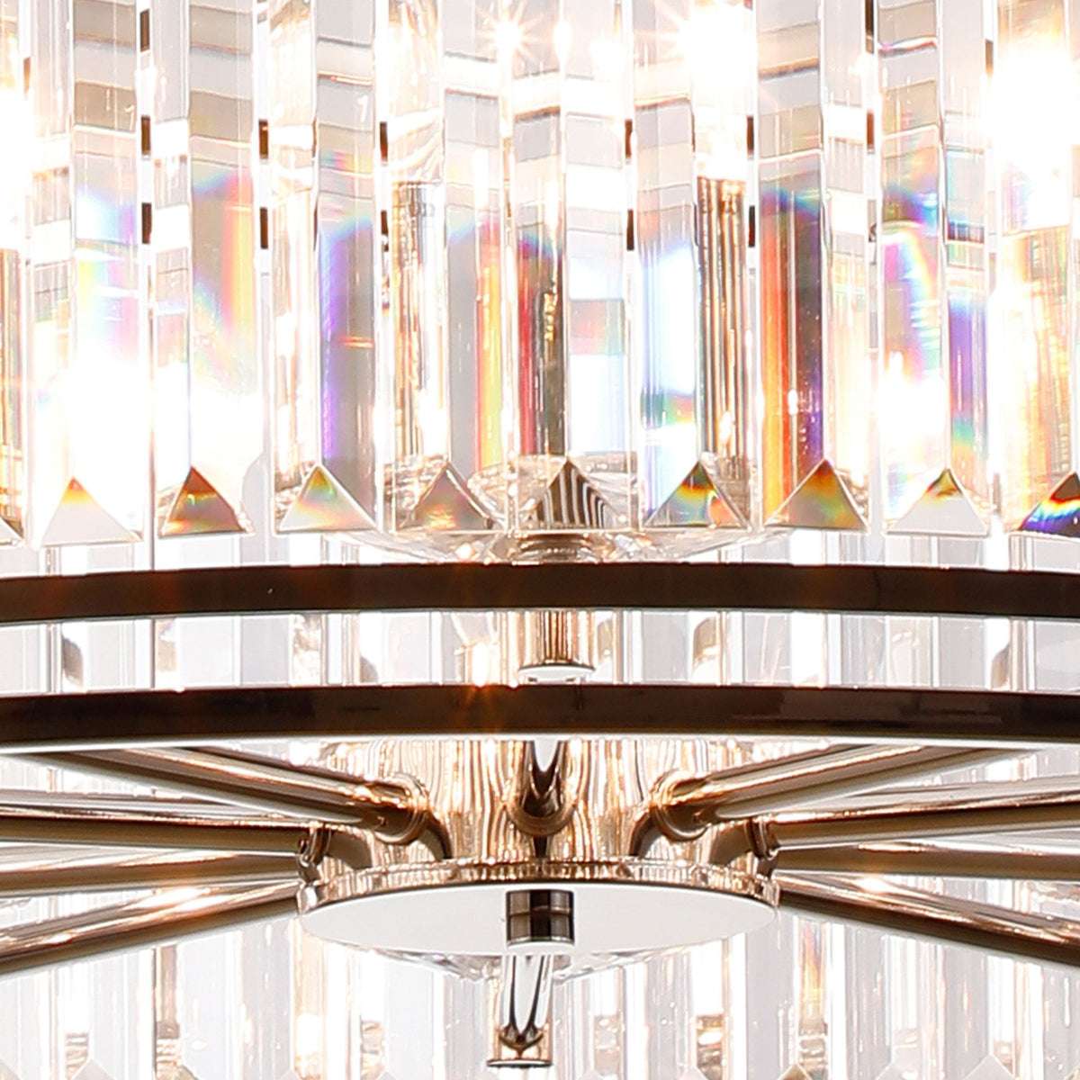 Close-up of a crystal chandelier with light refracting into rainbow colors.