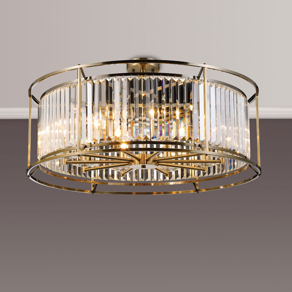 Round crystal chandelier with a brass frame and multiple light bulbs, mounted on a white ceiling.