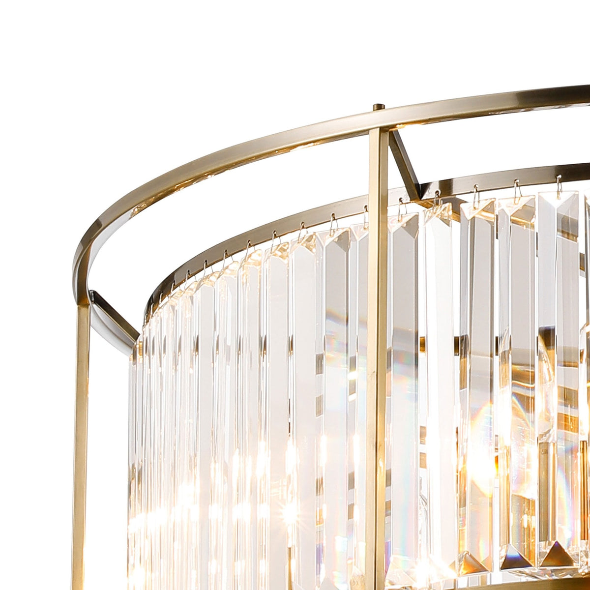 Close-up of a gold chandelier with rectangular crystal prisms hanging from its frame, reflecting light.