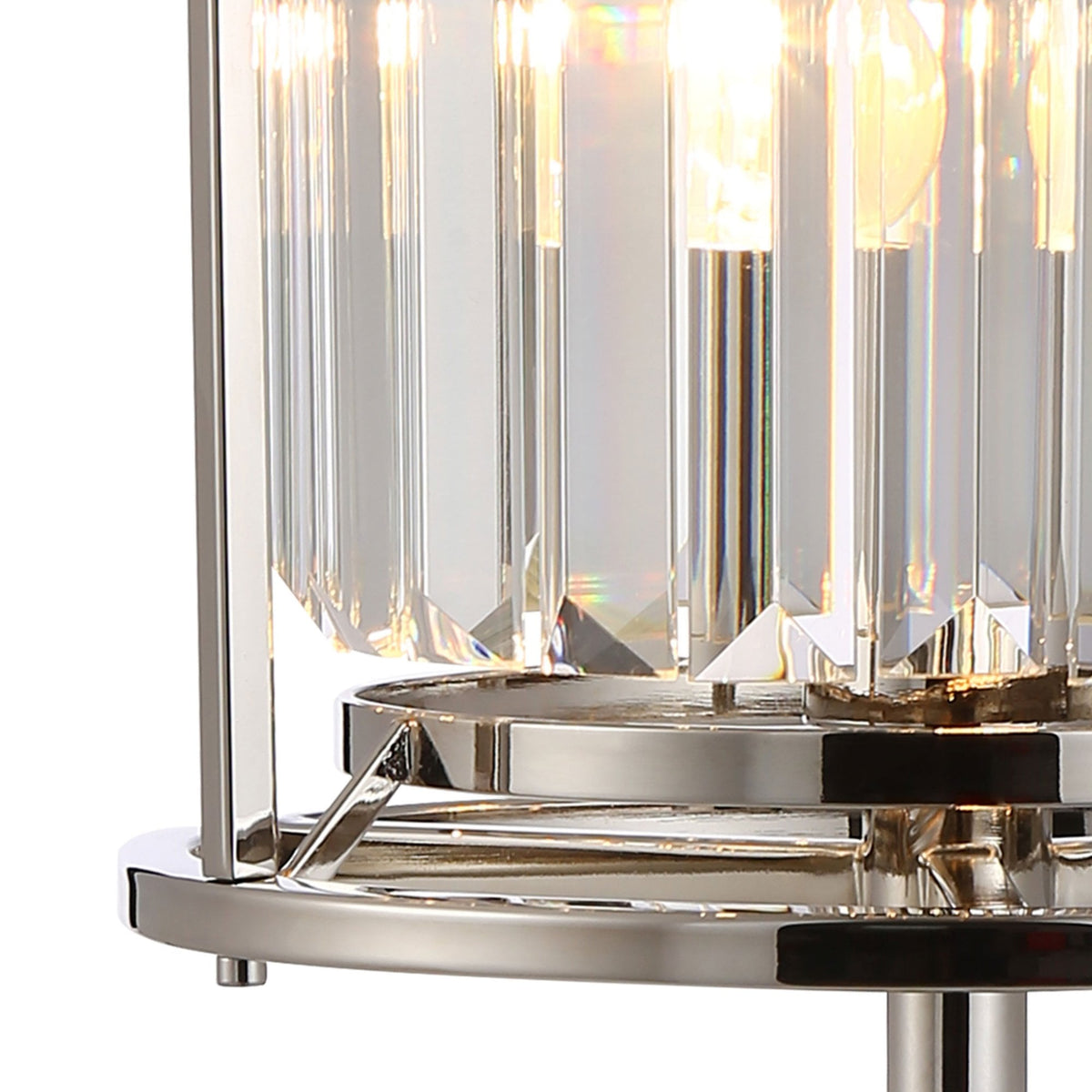 Close up of a crystal and chrome lamp base with light shining through the crystals