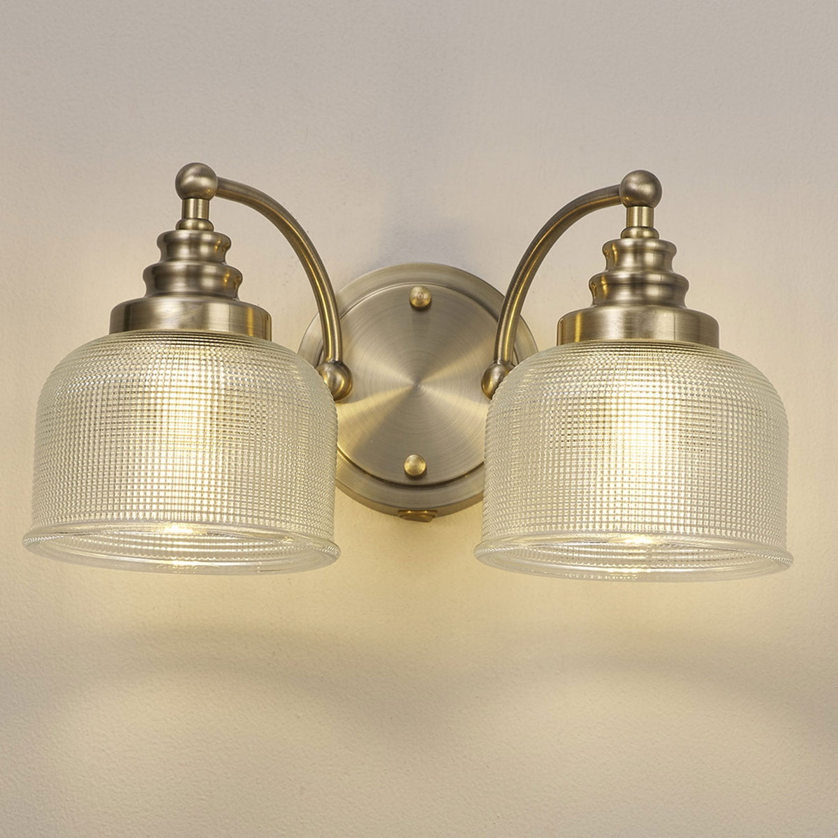 Stowford Switched Twin Wall Light Antique Brass & Clear Prismatic Glass