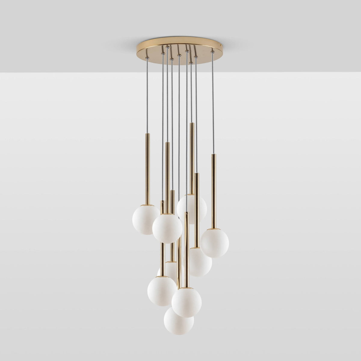 Alyssa Nine Drop G9 Cluster Pendant in Brass by houseof. Nine white globe lights hang from brass rods
