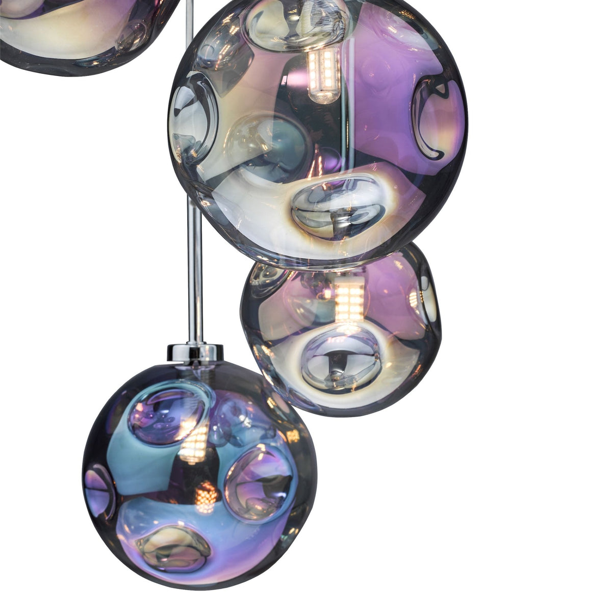 Close-up of a modern chandelier with iridescent glass globes, reflecting purple, blue, and amber hues.