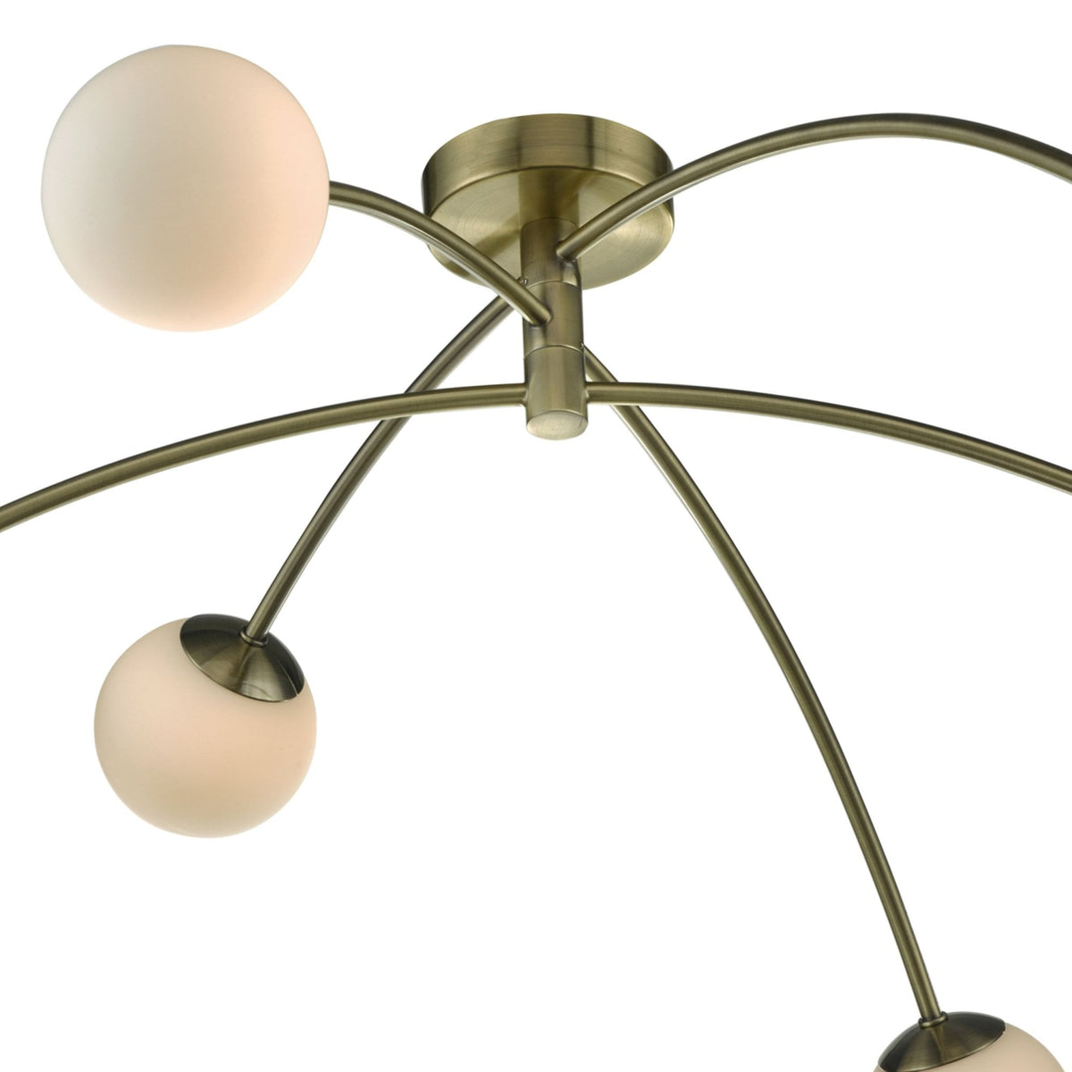 Close-up of a modern brass ceiling light with five curved arms, each holding a spherical frosted glass shade.