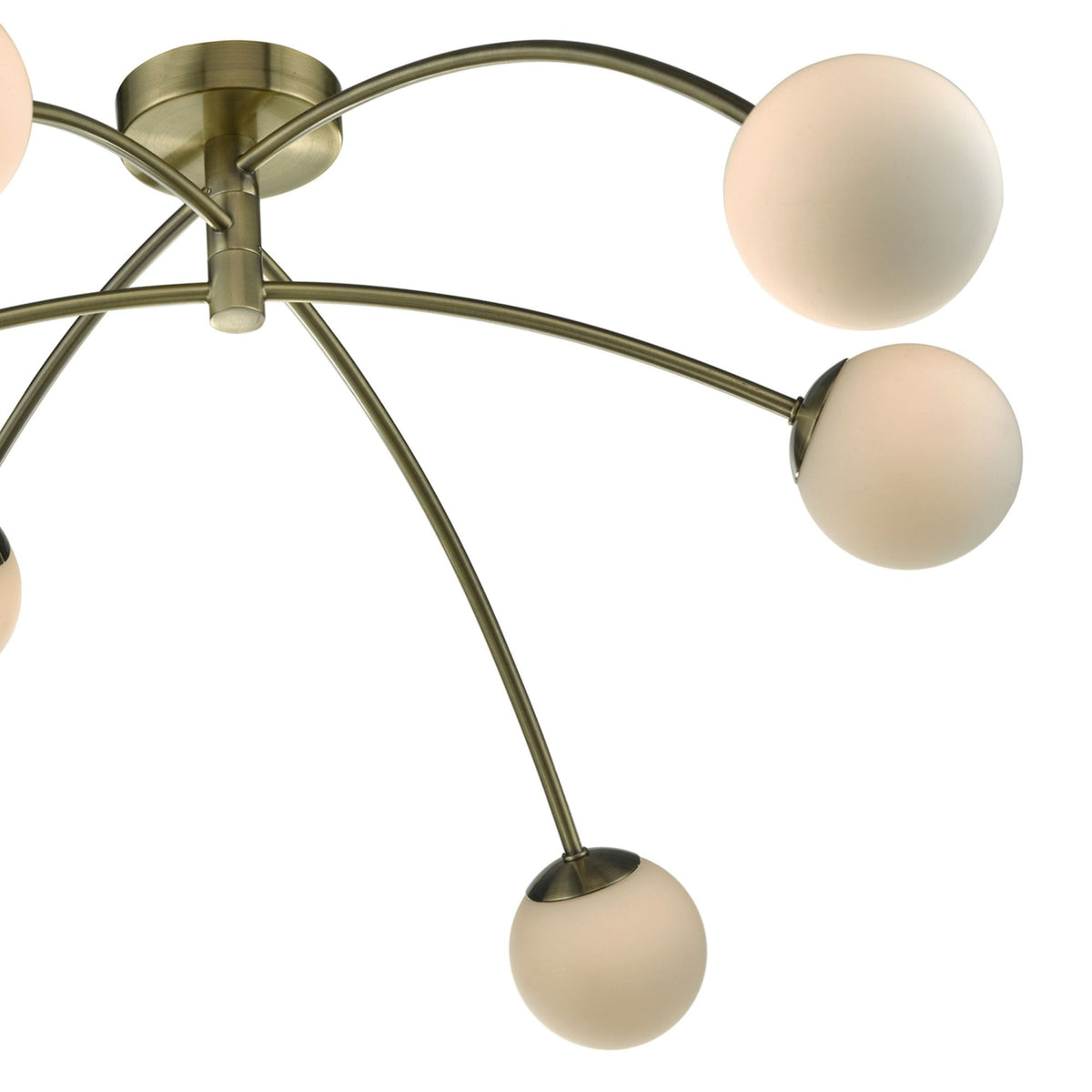Close-up of a modern ceiling light with brass arms and spherical frosted glass shades.