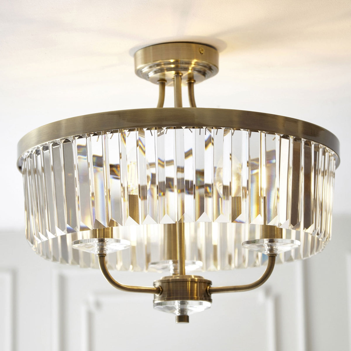 A close-up shot of the stunning Tiffany round semi-flush ceiling light with crystal detailing and brass fixtures.