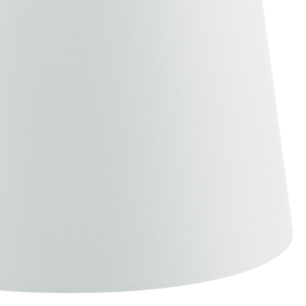 Close-up of a white fabric lampshade with a subtle vertical texture.