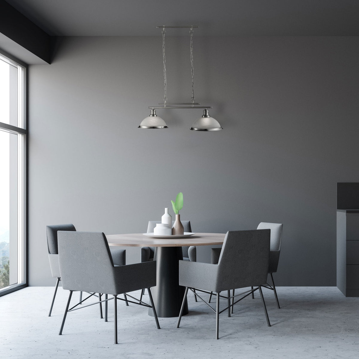 A modern dining room with a round table, four grey chairs, and a two-light pendant above.