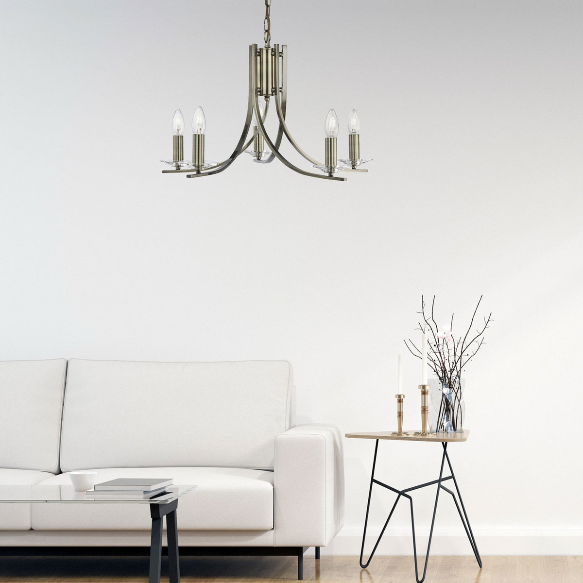 A five-light antique brass chandelier illuminating a modern living room.