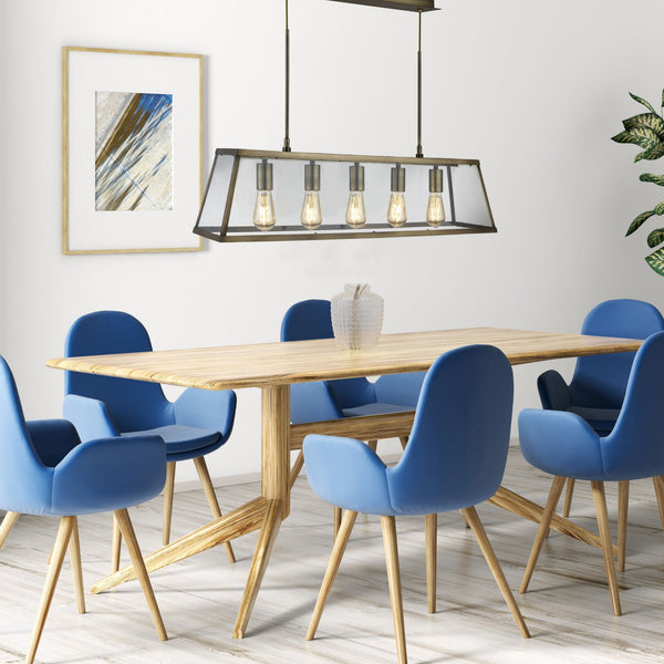 A brass-effect linear kitchen island pendant light hangs over a modern dining table.