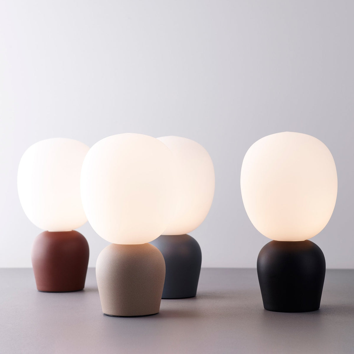 BELID Buddy Table Lamp in Seashell, with three other lamps in different colors