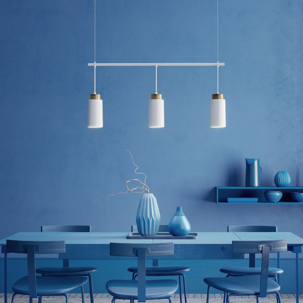 Three pendant lights hanging above a blue dining table.