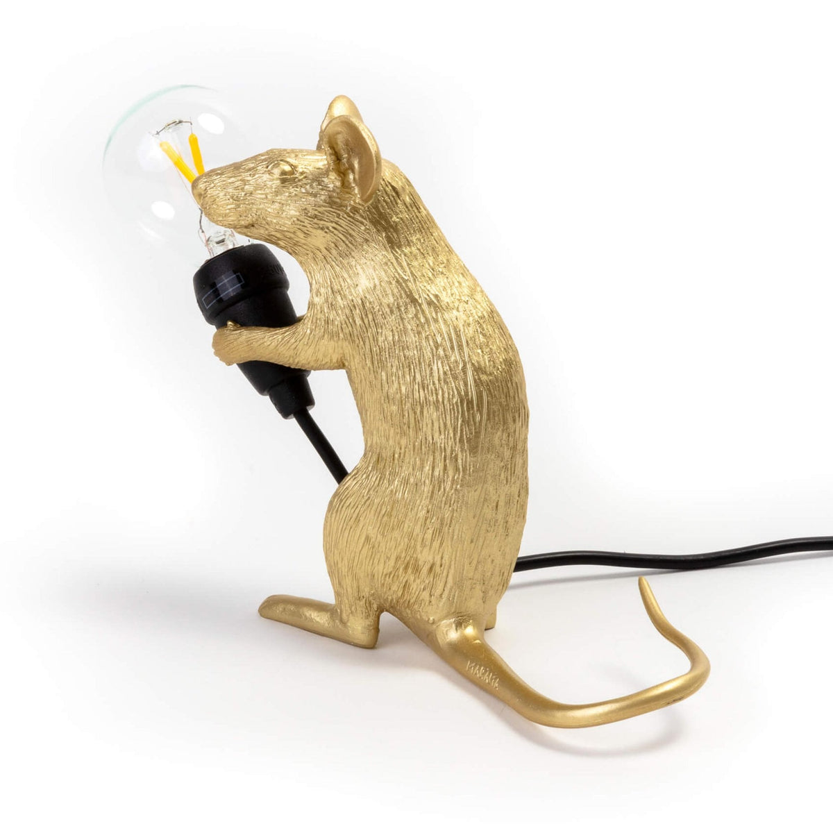 A golden mouse lamp holding a clear LED bulb, viewed from the right side.