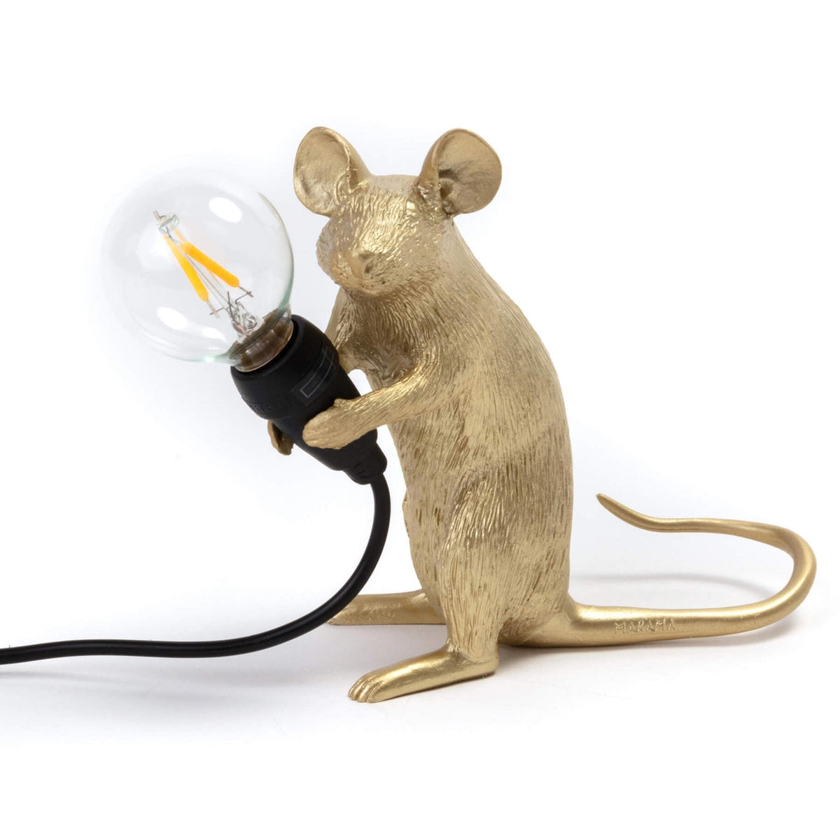 A golden mouse lamp holding a clear LED bulb, viewed from the front.