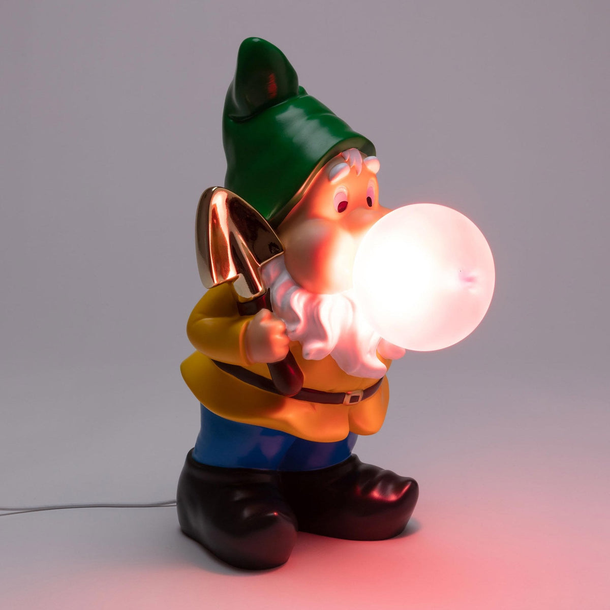 A garden gnome with a shovel, blowing a white glowing bubble gum bubble.