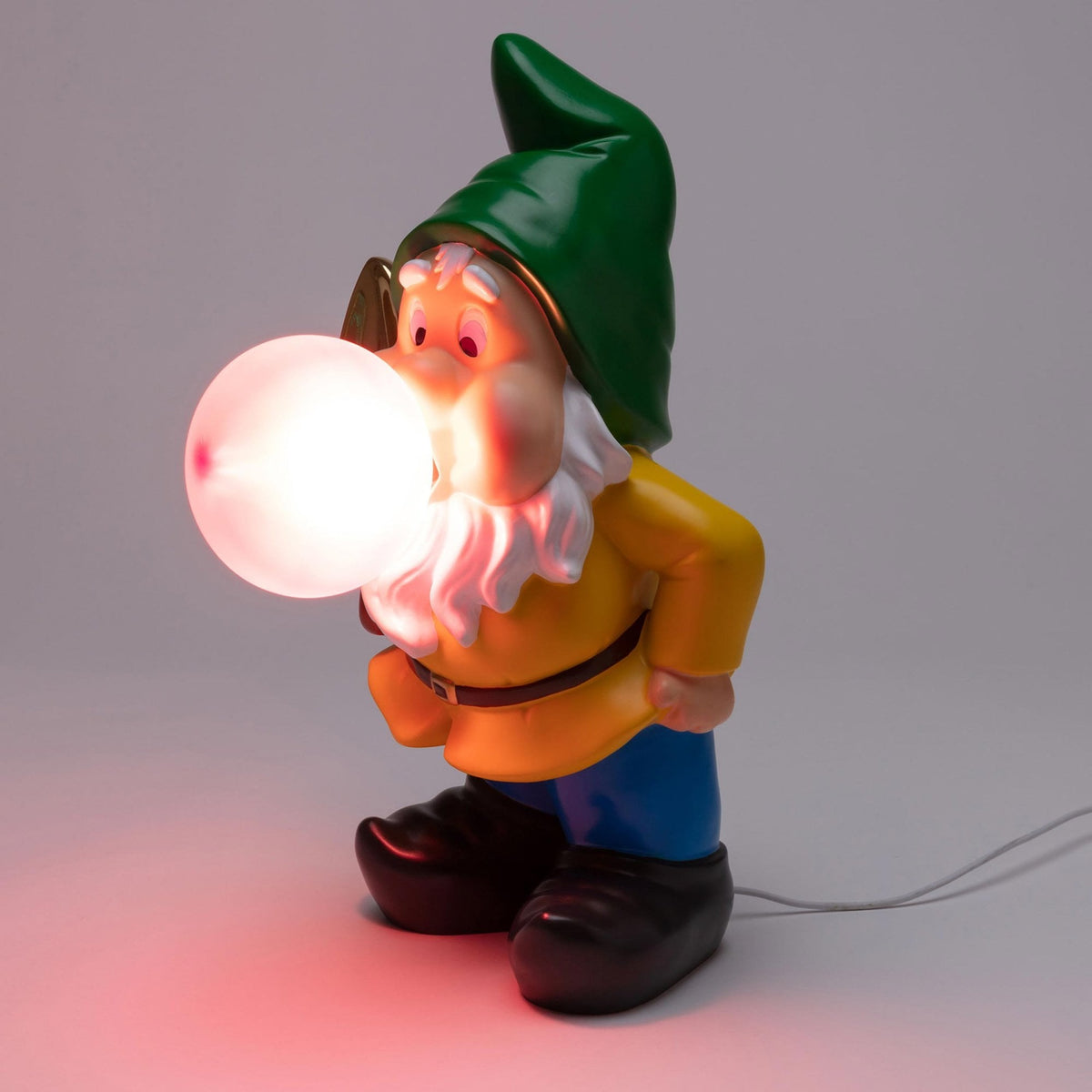 A garden gnome blowing a bright white glowing bubble gum bubble, viewed from the side.