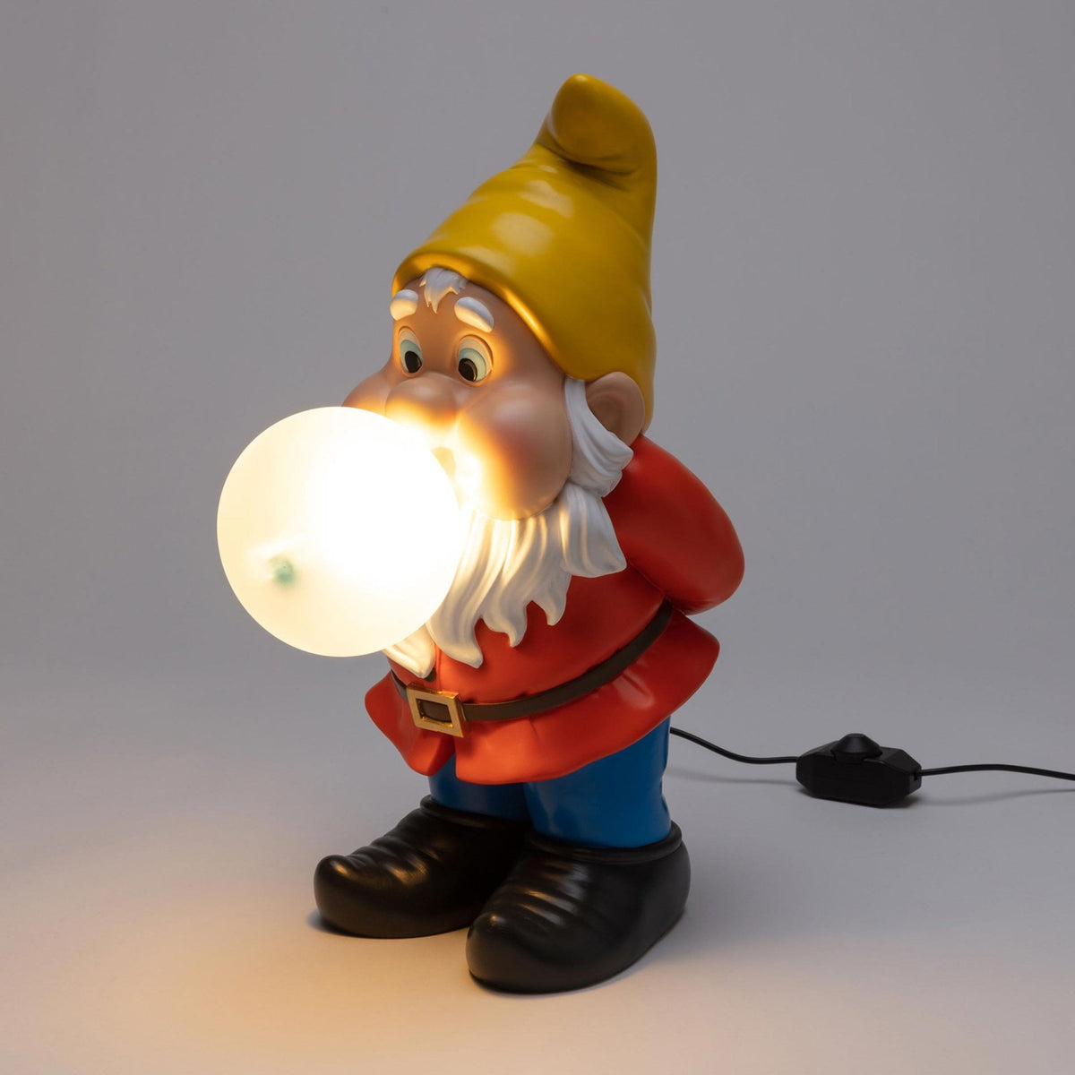 Seletti Gummy Dimmable Table Lamp Snooping Edition, a garden gnome with a glowing light bulb in its mouth