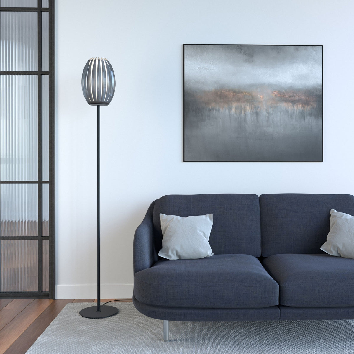 A floor lamp with a fluted glass shade, positioned in a modern living room setting.