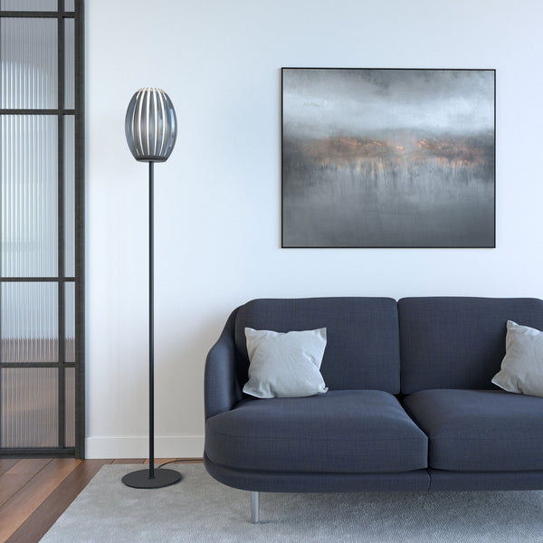 A floor lamp with a fluted glass shade, positioned in a modern living room setting.